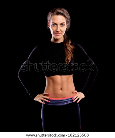 A picture of a fit woman posing over black background