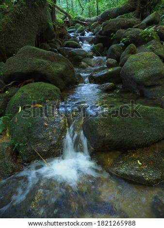 Peaceful Waterfall stock photo.Flowing stream through some rocks, blurred motion.