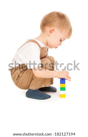 Thoughtful child playing with toys isolated on white