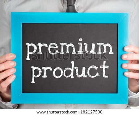 Man holding small blackboard with text premium product