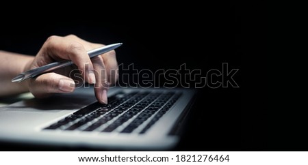 man using laptop or computer working at home in the at night for web banner with copy space. 