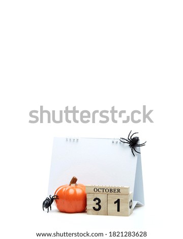 Wooden calendar October 31 with halloween decoration on a white background