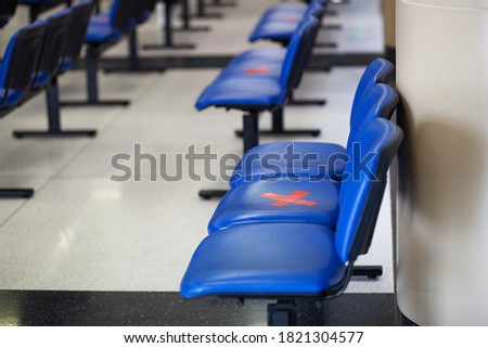 Social distancing concept in waiting room of hospital , reception room. Keep spaced between each chairs make separate for social distancing to avoid spreading illness during transmission of COVID-19.