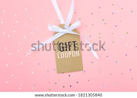 Gift discount coupon tag with glitter on pastel pink background