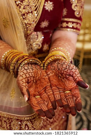 Pakistani Indian bridal showing henna design and hand jewellery Royalty-Free Stock Photo #1821365912