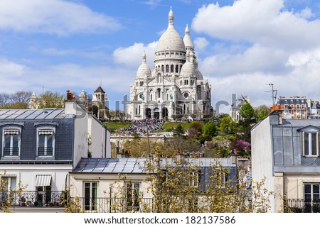 Paris, France, on April 29, 2013. View of Montmartre and cathedral Sakre-Ker from a house window in the sunny spring afternoon Royalty-Free Stock Photo #182137586