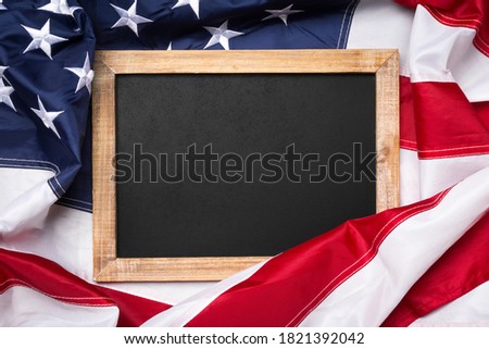 Blank blackboard over American flag as a concept for US national celebrations