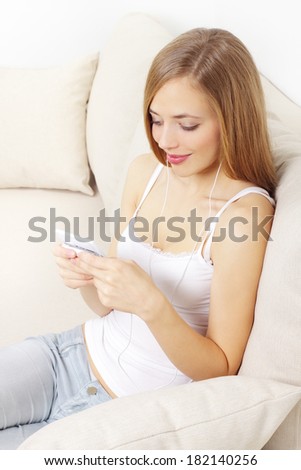 girl holding a mobile phone on light background
