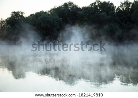 morning evaporation of water over the river, fog over the water Royalty-Free Stock Photo #1821419810