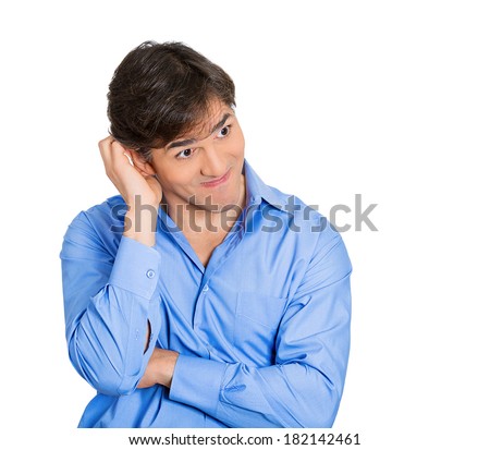 Closeup portrait of young adult man who is bothered by mistakes he has made, looking away nervous, isolated on white background. Negative human emotion facial expression feelings, body language. Royalty-Free Stock Photo #182142461