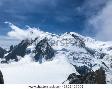 Chamonix-Mont-Blanc near the junction of France, Switzerland and Italy. Mont Blanc, the highest summit in the Alps, it is renowned for it its skiing.mountain with white snow and blue sky. Royalty-Free Stock Photo #1821427001
