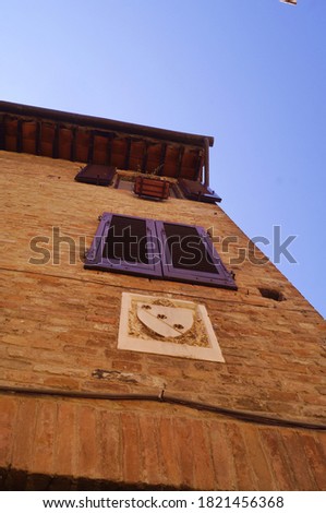 Coat of arms on a house in the ancient medieval village of Certaldo, Tuscany, Italy