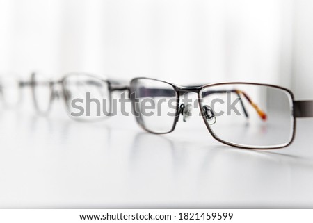 Pairs of metal frame prescription eye glasses isolated with a white background. Royalty-Free Stock Photo #1821459599