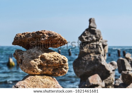 Minimalist aesthetics. Stones against the background of the sea and sky