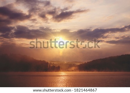 Sunrise on a misty lake Vlasina in the south of Serbia