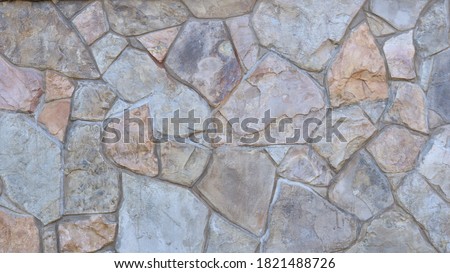 decorative stone cladding in a fragment of interior or exterior design using natural lightly processed large cobblestone Royalty-Free Stock Photo #1821488726