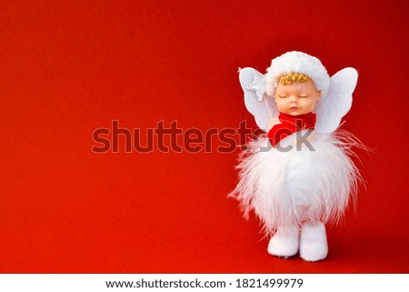 Cute Angel Christmas decoration on red background. Copy space. Greeting card. New year and Merry christmas