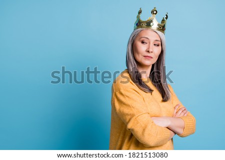 Kneel before queen. Photo of stunning gorgeous elegant senior lady arrogant look smug smile crown head watching servants clean house wear yellow jumper bright blue color background Royalty-Free Stock Photo #1821513080