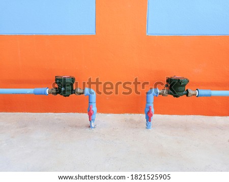 Water pipe and water meter picture Behind an orange wall