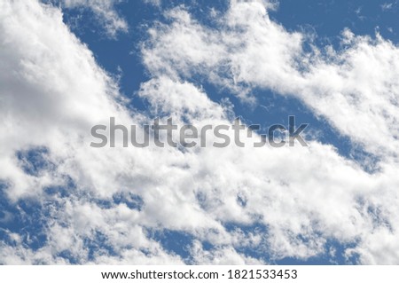 High quality photo of a blue sky with white and gray clouds. For backgrounds and photo editing in post-production.