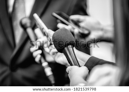 Media Interview - journalists with microphones interviewing formal dressed politician or businessman. Royalty-Free Stock Photo #1821539798