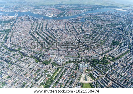 Aerial view from Amsterdam, Holland with the complete canal belt, seen from the Rijksmuseum. The grachtengordel is on the Unesco World Heritage List. In the back River IJ and the North bank.