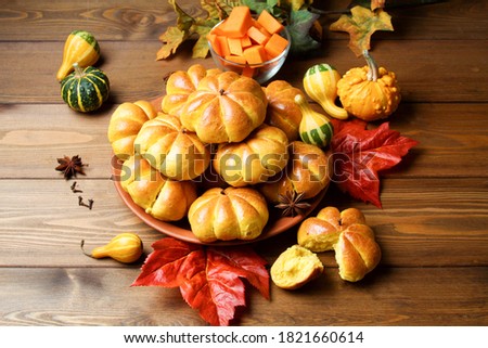 Pumpkin Buns Bread On Clay Plate On Wooden Table Black Background With Maple Leaves. Side View.