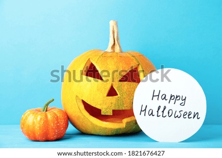 Halloween Pumpkin with decoration. Scary Jack on blue background. Top view