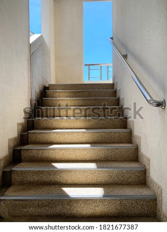 The sunlight shone down the stairs. On a blue sky day