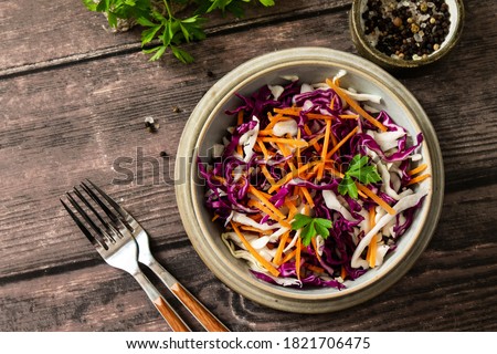 Salad Cole Slaw. Autumn Cabbage salad in a bowl on a rustic wooden table. Flat lay top view. Copy space. Royalty-Free Stock Photo #1821706475