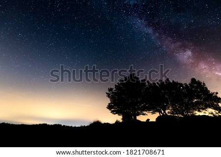 The Milky Way along the rock walls up to 160 meters high of the famous Swiss canyon Creux du Van. Night stellar sky in the Jura mountains between Canton Neuchâtel and Vaud, Switzerland, Europe
