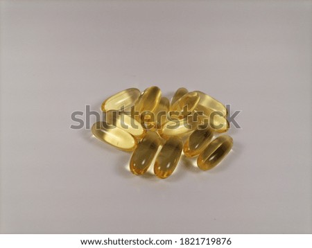 Capsules with fish oil on a light background