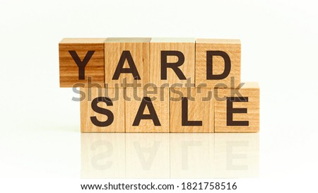 Yard sale word written on wood block. Yard sale text on white table for your desing, Front view concept.