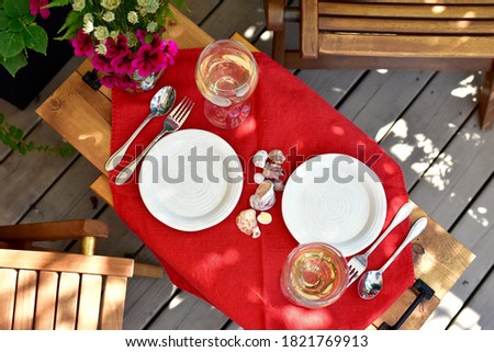 Patio deck and garden setting for secluded casual dining in home backyard for relaxing staycation evening on warm summer day