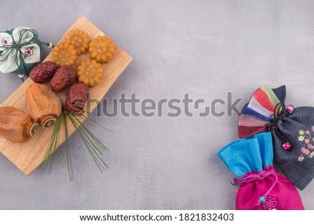 Korean dried persimmon and lucky bag background. Royalty-Free Stock Photo #1821832403