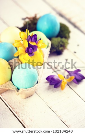 Easter eggs on wooden background. Easter background for design. Retro style, toned image. Selective focus.