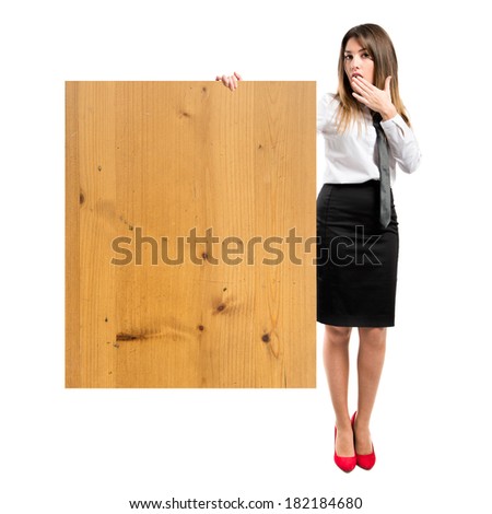 Young businesswoman holding placard over white background