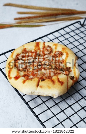 close view of mini pizza with blurry background