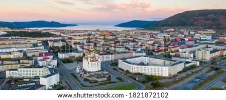 Beautiful panorama of the city of Magadan. Beautiful morning cityscape. Aerial view of the cathedral, streets, buildings, mountains and sea bay. Magadan, Magadan region, Russian Far East, Siberia. Royalty-Free Stock Photo #1821872102