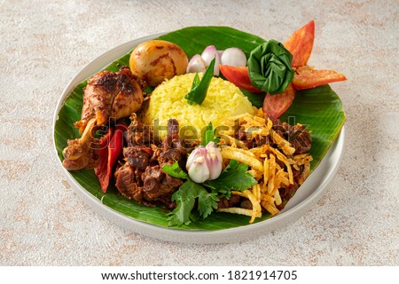 A typical Kalimantan food dish, namely Nasi Kuning Banjar. Royalty-Free Stock Photo #1821914705