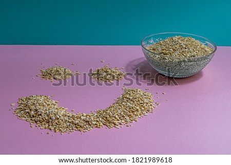 The simple life, oatmeal breakfast picture with interesting colours, cool pink and blue.  Start the day with a smile, great lighning in picture.  Original smily face, cornflakes corn, healthy food