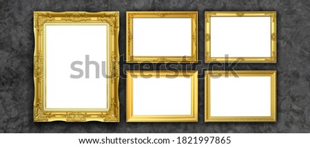 Empty Golden Picture Frame on concrete cement background.