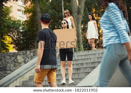 Dude with sign - woman stands protesting things that annoy her Royalty-Free Stock Photo #1822011902
