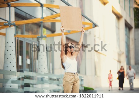 Dude with sign - woman stands protesting things that annoy her Royalty-Free Stock Photo #1822011911