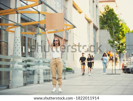 Dude with sign - woman stands protesting things that annoy her Royalty-Free Stock Photo #1822011914