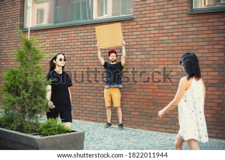 Dude with sign - man stands protesting things that annoy him Royalty-Free Stock Photo #1822011944