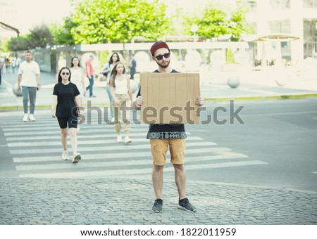 Dude with sign - man stands protesting things that annoy him Royalty-Free Stock Photo #1822011959