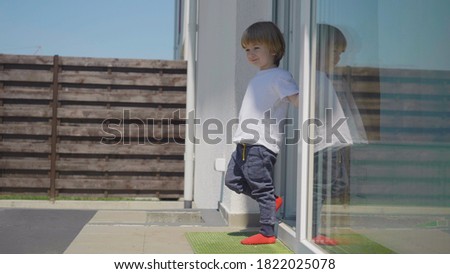 Little child leave the house the joy of freedom, boy looking around