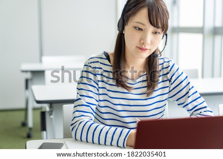 Asian female student taking online class. e-learning. Remote work. Royalty-Free Stock Photo #1822035401