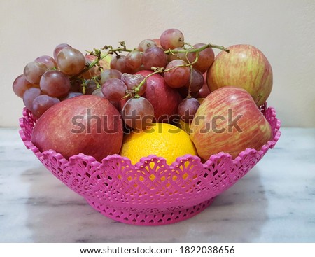 Basket full of mixed and colorful fruit.